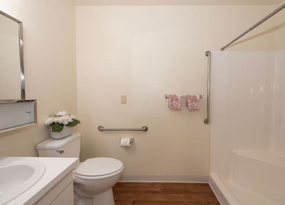 a bathroom with a toilet and a shower and a sink at Hilltop Commons Senior Living, Grass Valley, CA 95945
