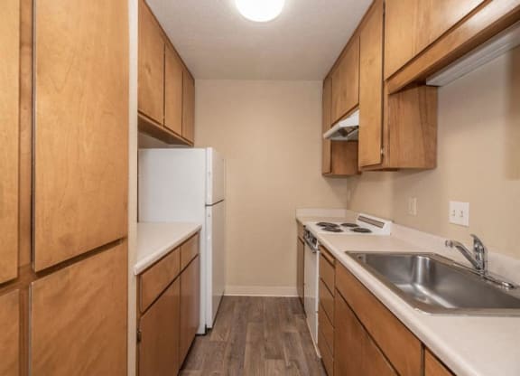 Full kitchen with refrigerator, cabinets and counter space at Lodi Commons Senior Living, California, 95240