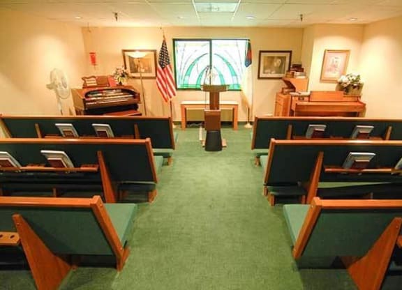 a church with empty benches and a podium at River Commons Senior Living, Redding, CA