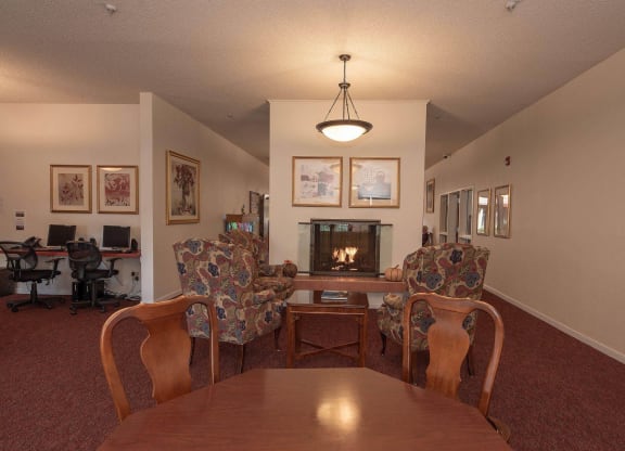 a living room with a table and chairs and a fireplace at Roseville Commons Senior Living, Roseville, 95678