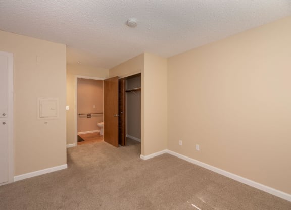 an empty living room with a door to a bathroom at Roseville Commons Senior Living, Roseville, CA 95678