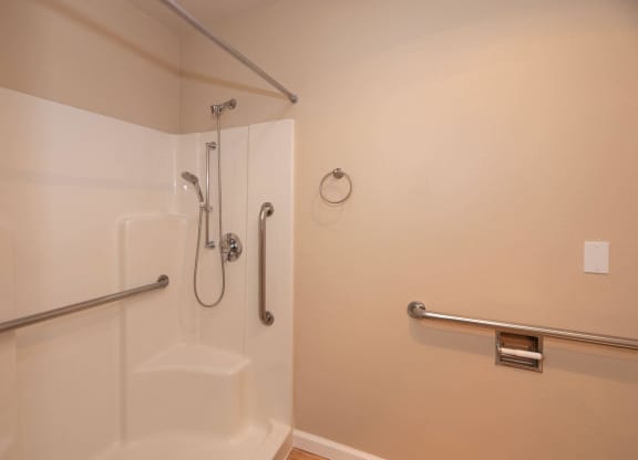 a bathroom with a shower and grab bars at Roseville Commons Senior Living, Roseville, 95678