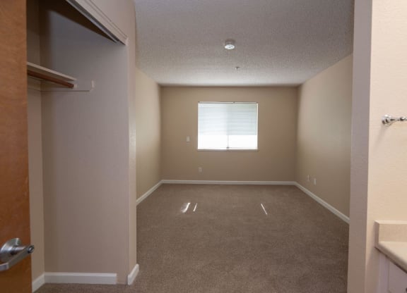 an empty room with a window and a closet at Roseville Commons Senior Living, Roseville, 95678