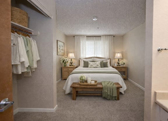 Master bedroom suite with walk-in closet and ensuite at Roseville Commons Senior Living Apartments, California, 95678