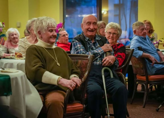 a group of elderly people sitting at a dining room table at Winding Commons Senior Living, Carmichael