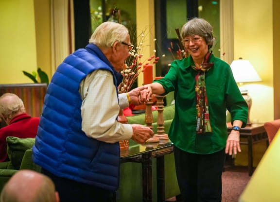 two women standing in a room talking to each other at Winding Commons Senior Living, Carmichael, CA, 95608