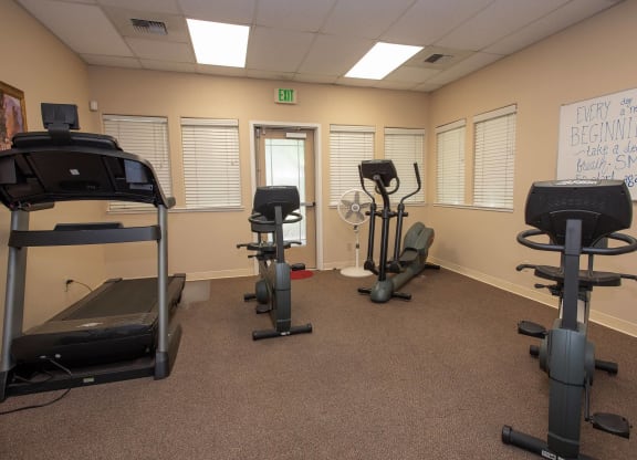 a gym with exercise equipment in a therapy room at Castle Vista Senior Duplex Community, Atwater, CA