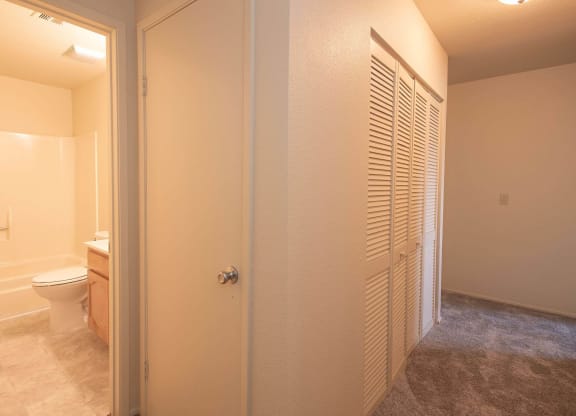 a bathroom with a toilet and a closet at Castle Vista Senior Duplex Community, Atwater