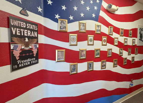 a display of an flag with pictures of veterans on it at Castle Vista Senior Duplex Community, Atwater, California