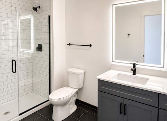 A white toilet sits next to a sink in a bathroom.