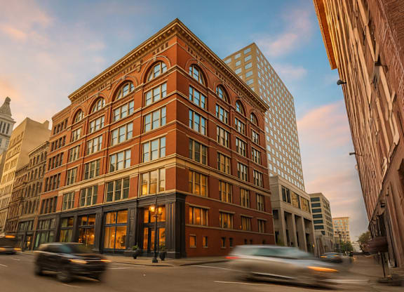 A red brick building with a street in front of it.