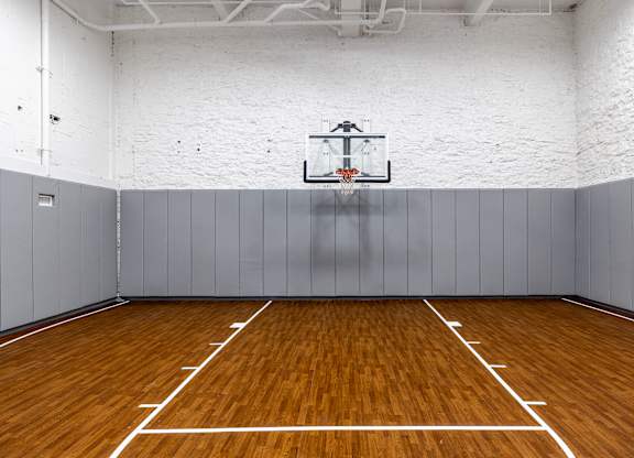 an empty basketball court in a gym with a basketball hoop at Textile Apartments, Cincinnati, OH, 45202