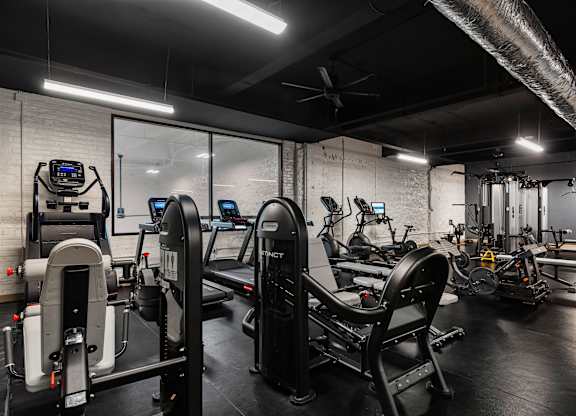 a gym with treadmills and other exercise equipment at Textile Apartments, Cincinnati