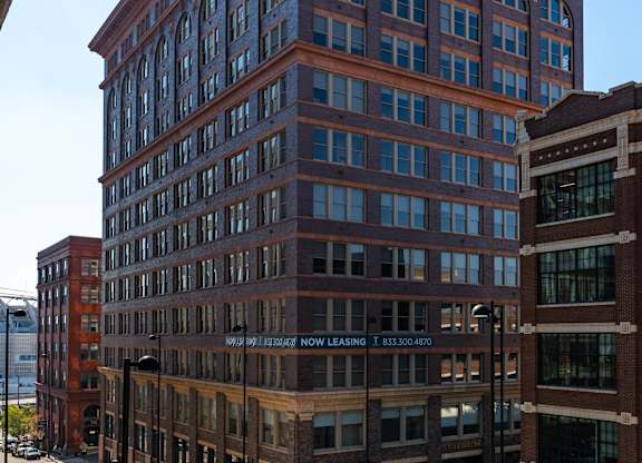 a tall brick building with a street in front of it at Textile Apartments, Cincinnati, OH