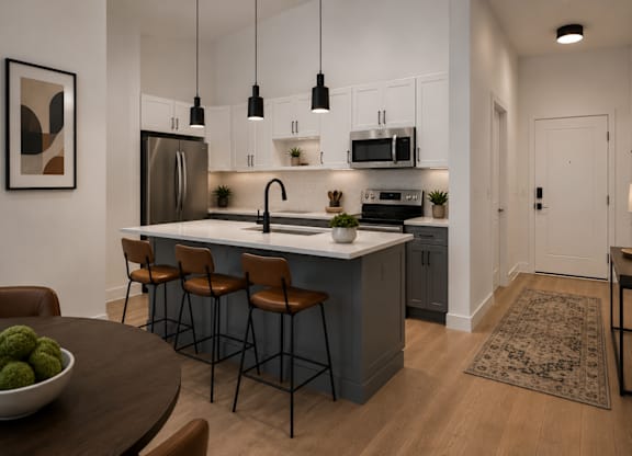 A modern kitchen with a bar area and a dining table.