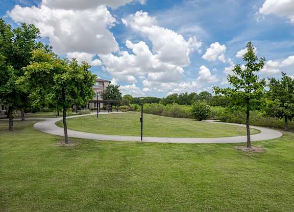 a park with trees and a circular walkway at Discovery at Craig Ranch, McKinney, TX