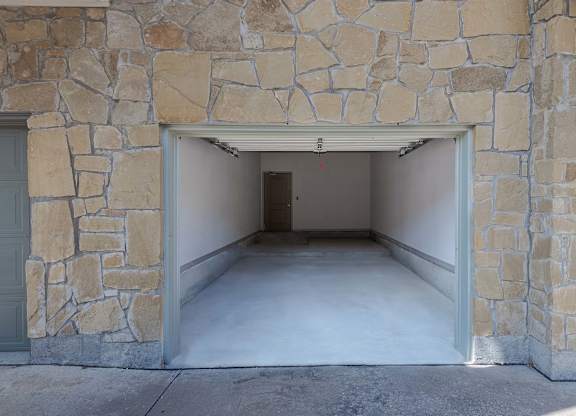a garage with an open door and a concrete floor at Discovery at Craig Ranch, McKinney, TX, 75070