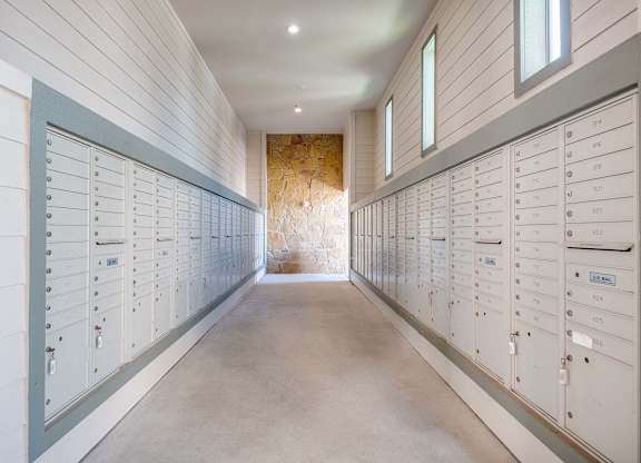 a row of lockers in a long room with a stone wall at Discovery at Craig Ranch, McKinney, Texas