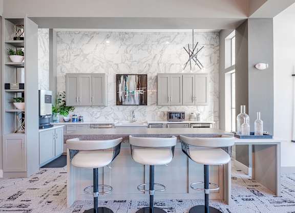 a white kitchen with a bar and white counter tops at Discovery at Craig Ranch, McKinney, Texas