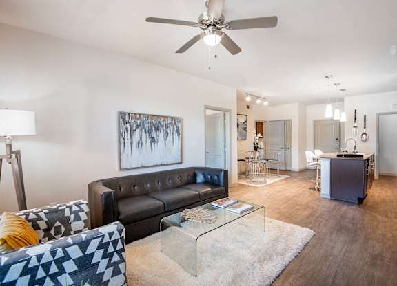 a living room with a couch and a glass table at Discovery at Craig Ranch, McKinney, TX