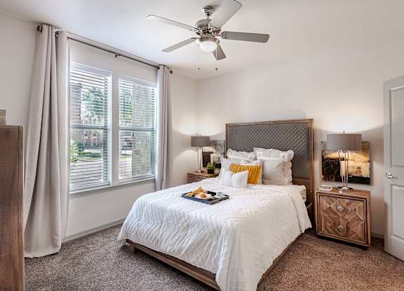 a bedroom with a large bed and a ceiling fan at Discovery at Craig Ranch, McKinney, Texas