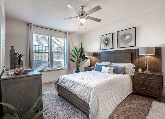 a bedroom with a bed and a ceiling fan at Discovery at Craig Ranch, McKinney, TX