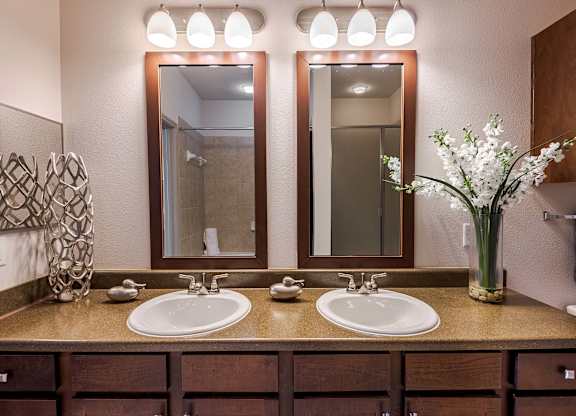 a bathroom with two sinks and two mirrors at Discovery at Craig Ranch, McKinney, 75070