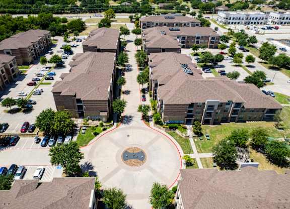 an aerial view of a neighborhood with houses and buildings and a circle in the middle at Discovery at Craig Ranch, McKinney, 75070