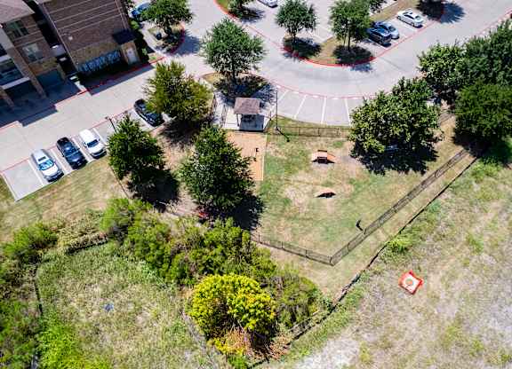 an aerial view of a yard with trees and a parking lot at Discovery at Craig Ranch, McKinney, TX, 75070