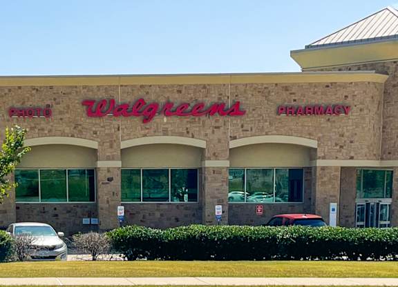 A Walgreens Pharmacy store with a red car parked in front at Discovery at Craig Ranch, McKinney, 75070