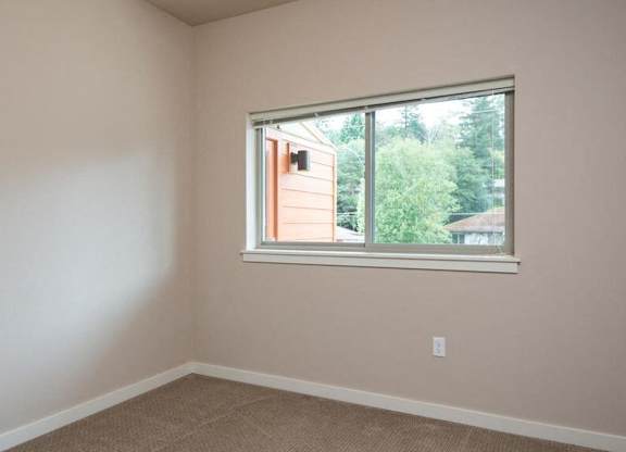 a bedroom with a large window and a