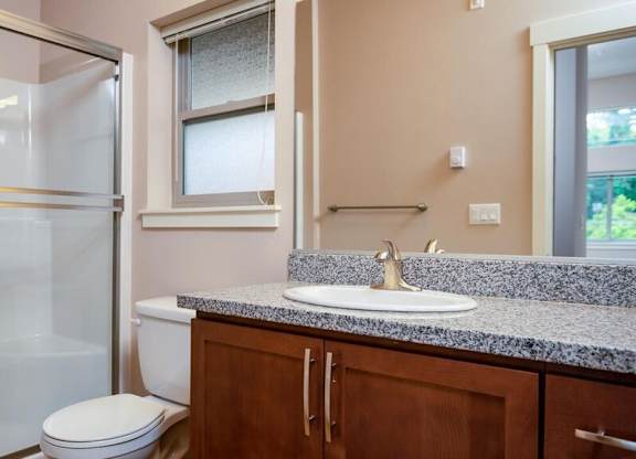 a bathroom with a sink toilet and shower