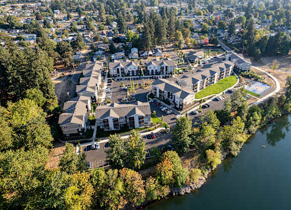 A bird's eye view of a residential area with houses and a lake.