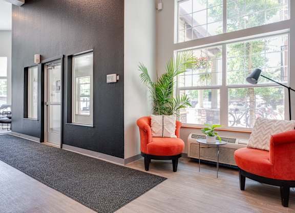 A room with a black wall and a red chair.