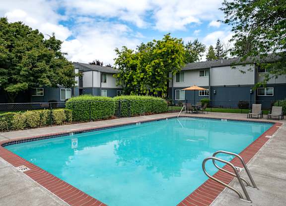 A swimming pool surrounded by a red border and a metal ladder.