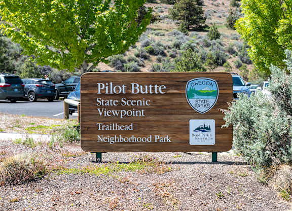 A wooden sign for Pilot Butte State Scenic Viewpoint Trailhead Neighborhood Park.