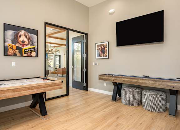A room with a pool table and a television.