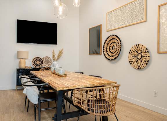 A dining room with a wooden table and chairs.