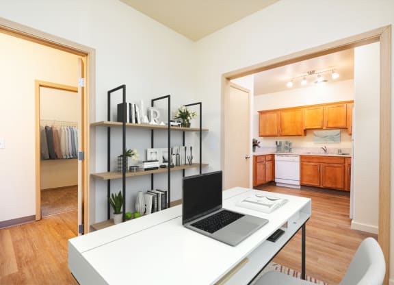a home office with a laptop computer sitting on top of a desk