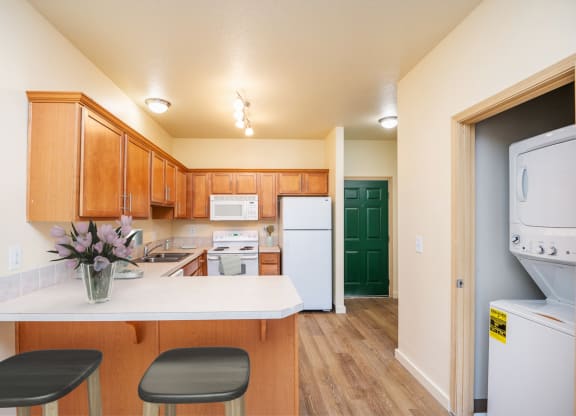 a kitchen with white appliances and wooden cabinets