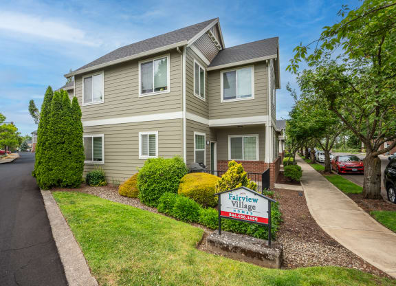 a house with a for sale sign in front of it