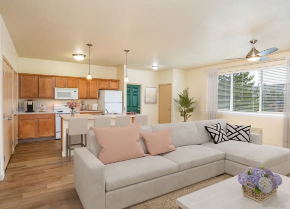 a living room and kitchen with a couch and a table