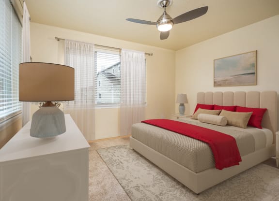 a bedroom with a bed and a ceiling fan