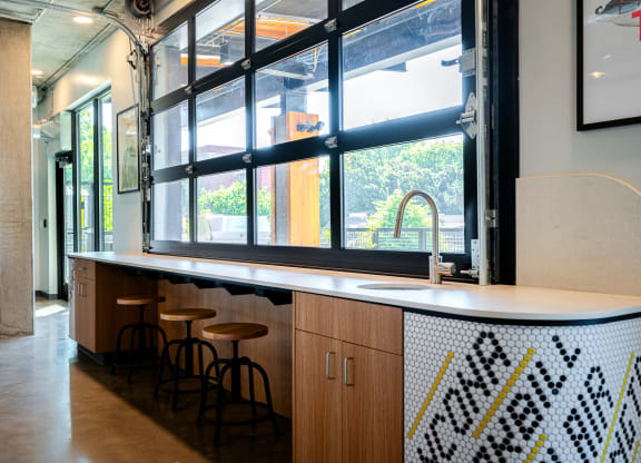 a counter and stools in front of a window