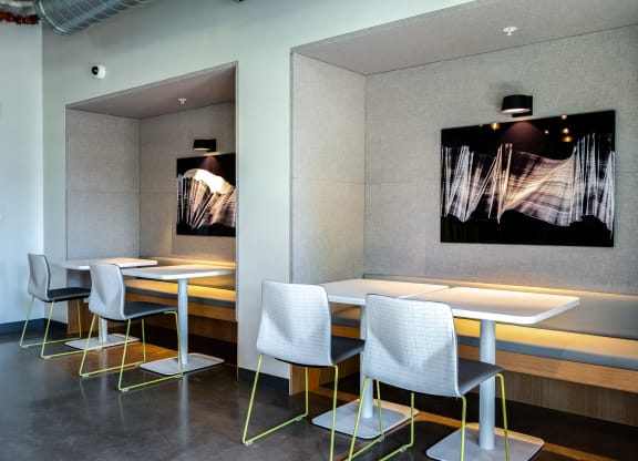 flock13 resident lounge study seating with tables and chairs and a painting on the wall