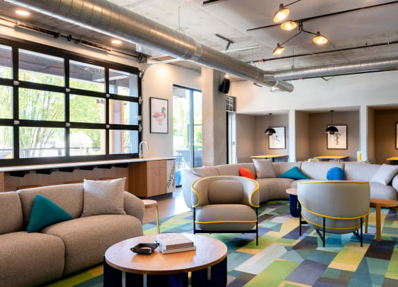 a lounge room with couches and chairs and a table