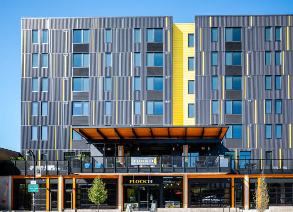 a modern apartment building with a yellow and grey facade