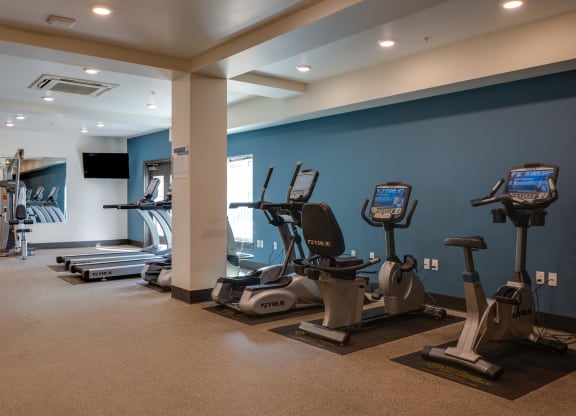 a gym with treadmills and other exercise equipment in a building