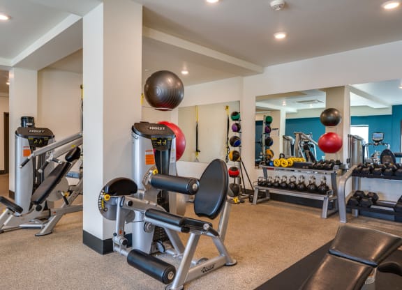 a gym with weights and other exercise equipment and a bowling ball