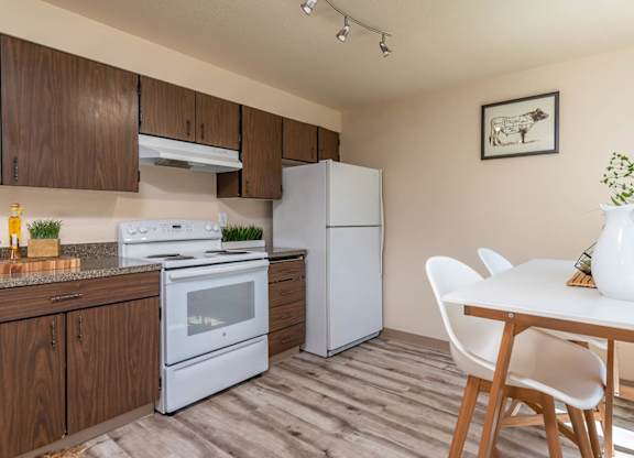 Model Kitchen with wood cabinetry and white appliances